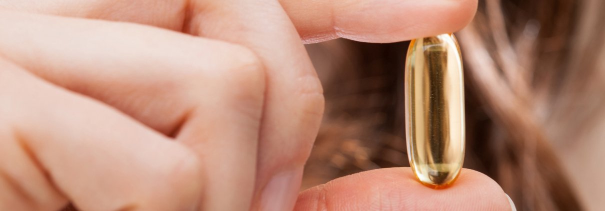 Woman hand showing best hair supplement