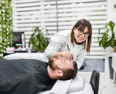 Preparation Of Male Patient For Hair Loss Treatment By Female Doctor In Modern Clinic
