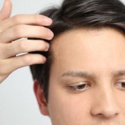 Young man's forehead swiping his hair off